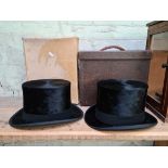 Two vintage Dunn & Co silk top hats in original cases.