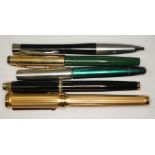 A group of five vintage pens comprising a fluted gold plated oversized pen with Iridium nib, a