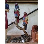 A leaded glass lamp modelled as two parrots.