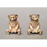 Two Edwardian silver novelty pepper pots in the form of seated teddy bears with detachable heads,