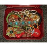 A box containing vintage costume jewellery including white metal, coral etc.