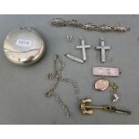 A metal box containing various white metal and silver items including silver ingot pendant,