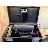 A circa 1950s - 1960s Singer Featherweight Convertible electric portable sewing machine, model 222K,