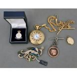 A mixed lot including a 9ct gold front and back locket, a hallmarked silver fob, a modern pocket