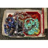 A box of costume jewellery comprising mainly beaded jewellery including amethyst, carnelian, blue