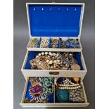 A jewellery box containing vintage and modern costume jewellery including necklaces, earrings,