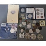 A tin of world coins, tokens & medals.