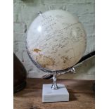 A vintage globe on marble base.