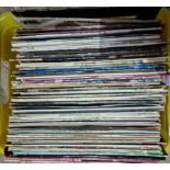 A box of assorted LP records.