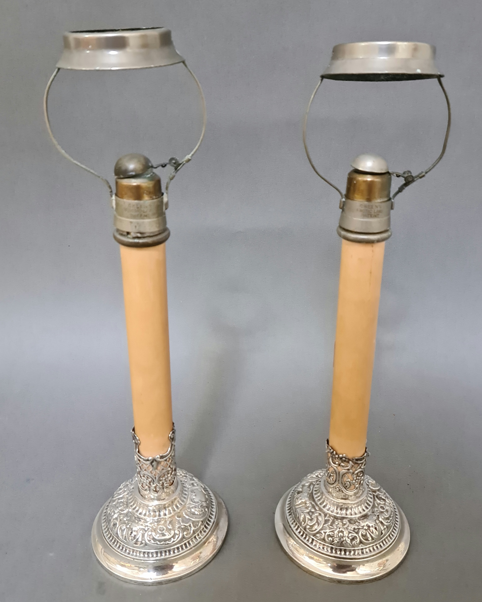 Pair of late Victorian silver candle stands with embossed decoration London 1897, William Comyns,