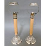 Pair of late Victorian silver candle stands with embossed decoration London 1897, William Comyns,