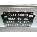 A vintage cast metal sign; 'Flat shoes only to be worn on the bowling green'.