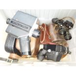 A box of assorted cameras and binoculars including Polavision, Goerz.