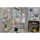 A tin of GB and world coins and banknotes