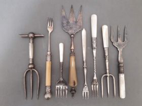 A variety of silver plated bread and pickle forks with mother of pearl handles etc.