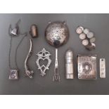 A collection of silver and white metal items including small notes book, tea strainer, ingot