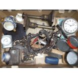A box of assorted items including a Westclox Big Ben alarm clock, an ornate metal photograph