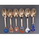 A set of six Danish silver gilt and enamel year spoons each with a different enamelled design and
