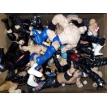 A box of assorted wrestling figures.