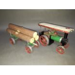 A Mamod steam traction engine and log trailer.