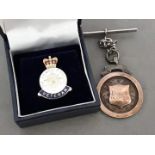 A HM ARmed Forces Veteran badge and a hallmarked silver fob.