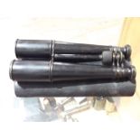 A pair of French "Long Tom" binoculars engraved C. Armand Paris, with leather case.