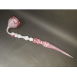 A large Nailsea pink glass pipe, length 83cm.