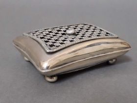 An Edwardian silver box modelled as a cushion with grille work top and ball feet, William Comyns &
