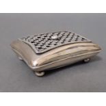 An Edwardian silver box modelled as a cushion with grille work top and ball feet, William Comyns &