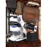 A crate of assorted cameras including a Minolta 5000, a Polaroid 101, an antique plate camera,