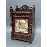 An oak cased Victorian Gothic revival mantel clock with pendulum and key, height 45cm.