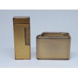 A gold plated Dunhill lighter and a Colibri lighter.