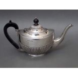 A silver tea pot with ebonised wood handle and finial, Joseph Gloster Ltd, Birmingham 1902, gross