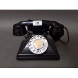 A GPO no. 164 black bakelite telephone.