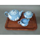 A three piece Wedgwood Jasper tea set comprising teapot, milk and sugar.