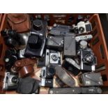 A crate of assorted vintage cameras including Minolta, Miranda, Zenit, Fujica etc.