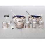 A selection of silver and white metal items to include two salts with cobalt blue liners and spoons,