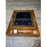 An antique writing slope with brass escutcheon and corners.