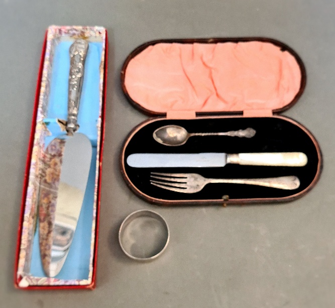 A cased non-matching set of 3 to include a fork, a small teaspoon and a spread knife together with a
