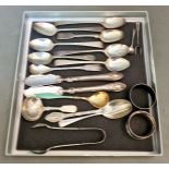 A collection of hallmarked silver items including various spoons, two master butter spreaders, two