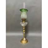 A late Victorian brass and green glass peg lamp.