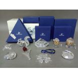 Nine Swarovski crystal ornaments, all with boxes.