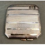 A hallmarked silver engine turned cigarette curved case, Samuel M Levi, Birmingham, 1931, gross