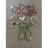 Assorted costume jewellery including a jade and simulated pearl necklace, marcasite brooches, etc.