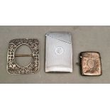 A collection of silver and white metal items including a cards case, a vesta case and a buckle,