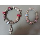 A silver SimStars charms bracelet with various silver and white metal charms, many marked 925