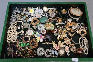 A tray of vintage costume jewellery including some silver.