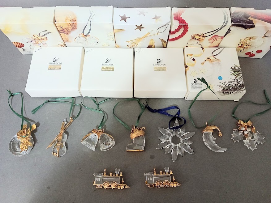 Nine Swarovski crystal christmas ornaments, all with boxes.