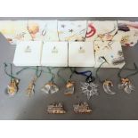 Nine Swarovski crystal christmas ornaments, all with boxes.