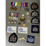 Military interest - a mixed lot of medals, badges and cloth patches to include a medal awarded to